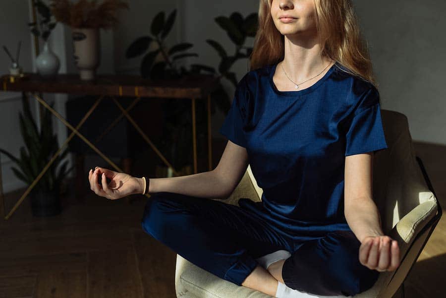 Žena medituje v křesle